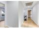 Bright hallway featuring hardwood floors and updated doors with dark hardware at 5465 N Fork Sw Dr, Lilburn, GA 30047