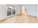 Bright and airy living room featuring hardwood floors and a large window view to the front yard at 5465 N Fork Sw Dr, Lilburn, GA 30047