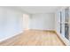 Bright and airy living room featuring hardwood floors and a large window view to the front yard at 5465 N Fork Sw Dr, Lilburn, GA 30047