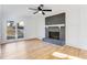 Inviting living room with brick fireplace, light wood floors, lots of natural light, and white trim at 5465 N Fork Sw Dr, Lilburn, GA 30047