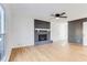 Bright living room featuring a painted brick fireplace, wood flooring, and fresh, neutral paint at 5465 N Fork Sw Dr, Lilburn, GA 30047