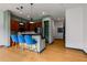Modern kitchen featuring dark wood cabinets, black countertops, and three stylish blue bar stools at 747 Ralph Mcgill Ne Blvd # 223, Atlanta, GA 30312