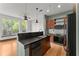 Open kitchen featuring stainless steel appliances, granite counters and breakfast bar with hardwood floors at 747 Ralph Mcgill Ne Blvd # 223, Atlanta, GA 30312