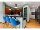 Modern kitchen featuring dark wood cabinets, black countertops, and three stylish blue bar stools at 747 Ralph Mcgill Ne Blvd # 223, Atlanta, GA 30312
