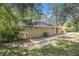Brick home exterior with small back patio and grassy yard surrounded by trees at 1667 Hollyhock Ter, Decatur, GA 30032