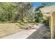 Spacious backyard with a small concrete patio, grassy lawn, and mature trees at 1667 Hollyhock Ter, Decatur, GA 30032