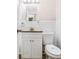 Bathroom featuring a toilet, mirror, sink with granite countertop, and white cabinets at 1667 Hollyhock Ter, Decatur, GA 30032