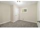Neutral bedroom with plush carpet, natural light, and a closet at 1667 Hollyhock Ter, Decatur, GA 30032