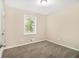 Comfortable bedroom with neutral carpet and walls, creating a peaceful and serene environment at 1667 Hollyhock Ter, Decatur, GA 30032