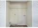 Empty laundry room or closet, ready for washer and dryer, with shelving and hookups installed at 1667 Hollyhock Ter, Decatur, GA 30032