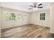 Bright living room features hardwood floors, large windows, and a ceiling fan at 1667 Hollyhock Ter, Decatur, GA 30032