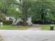 Cozy single-story home nestled among mature trees with a private driveway and well maintained front yard at 2771 Georgian Dr, Brookhaven, GA 30341