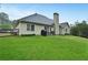Spacious backyard with green lawn, patio furniture, and fenced perimeter at 59 Sentry Rdg, Dallas, GA 30157