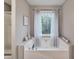 Bathroom featuring a large soaking tub with a view to the outdoors at 59 Sentry Rdg, Dallas, GA 30157