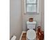 Small bathroom with neutral paint, wood floors and toilet at 59 Sentry Rdg, Dallas, GA 30157