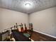 Bedroom with wood floors, guitars, keyboard, and textured ceiling at 59 Sentry Rdg, Dallas, GA 30157