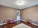 Bedroom with wood floors, textured ceiling, and a play area with a table and chairs at 59 Sentry Rdg, Dallas, GA 30157