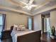 Bedroom features a tray ceiling with fan, hardwood floors, and a view of a window at 59 Sentry Rdg, Dallas, GA 30157