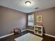 Bedroom featuring a window, bookshelf, hardwood floors, and neutral-colored walls at 59 Sentry Rdg, Dallas, GA 30157