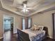 Bedroom featuring a tray ceiling with fan, hardwood floors, and a view of a window at 59 Sentry Rdg, Dallas, GA 30157