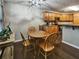 Cozy dining area adjacent to kitchen features wooden chairs, an oval table, and natural light from nearby windows at 59 Sentry Rdg, Dallas, GA 30157