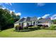 Expansive one-story home featuring a beautifully landscaped yard with flowering shrubs, lush green lawn, and mature trees at 59 Sentry Rdg, Dallas, GA 30157