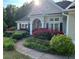 Charming single-story home featuring a landscaped front yard with flowering bushes, lush plants and a winding walkway at 59 Sentry Rdg, Dallas, GA 30157