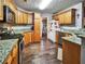 The kitchen features stainless steel appliances, granite countertops, wood floors, and wooden cabinets at 59 Sentry Rdg, Dallas, GA 30157