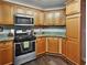 A kitchen features granite countertops, stainless steel appliances, wood floors, and wooden cabinets at 59 Sentry Rdg, Dallas, GA 30157