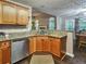 A kitchen features granite countertops, stainless steel appliances, wood floors, and wooden cabinets at 59 Sentry Rdg, Dallas, GA 30157