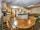 A kitchen features wooden cabinets, granite countertops, stainless steel appliances, and a wooden dining table at 59 Sentry Rdg, Dallas, GA 30157