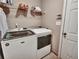 Modern laundry room featuring a new washer and dryer and overhead storage at 59 Sentry Rdg, Dallas, GA 30157