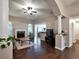 Inviting living room with hardwood floors, a stone fireplace, neutral tones, and seamless connection to the breakfast area at 59 Sentry Rdg, Dallas, GA 30157