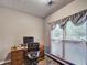 Home office featuring a wood desk, office chair, window with blinds and curtains, and an area rug at 59 Sentry Rdg, Dallas, GA 30157
