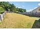 View of the expansive backyard with a partial fence and a small patio area at 7431 St David St, Fairburn, GA 30213