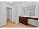 Bathroom features a large mirror, wood vanity and sink, and a walk-in closet at 7431 St David St, Fairburn, GA 30213