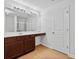 Bathroom features a large mirror, wood vanity and sink, and a walk-in closet at 7431 St David St, Fairburn, GA 30213