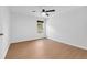 Bedroom with wood-look flooring, a ceiling fan, a window, and white painted walls at 7431 St David St, Fairburn, GA 30213