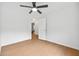 Bright bedroom features a ceiling fan, light hardwood floors, and white walls at 7431 St David St, Fairburn, GA 30213