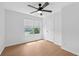 Light and airy bedroom with hardwood floors, ceiling fan, and bright window at 7431 St David St, Fairburn, GA 30213