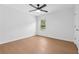 Bright bedroom boasts hardwood floors, a ceiling fan, and a large window at 7431 St David St, Fairburn, GA 30213