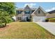 Charming two-story home with a two-car garage and well-maintained front lawn at 7431 St David St, Fairburn, GA 30213