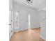 Inviting foyer with hardwood floors, natural light, and entry to the staircase at 7431 St David St, Fairburn, GA 30213