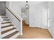 Inviting foyer with hardwood floors, a staircase and an entry door at 7431 St David St, Fairburn, GA 30213