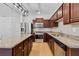 Modern kitchen featuring stainless steel appliances, granite countertops, and wood cabinetry at 7431 St David St, Fairburn, GA 30213