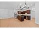 Open kitchen with stainless appliances, wood cabinets, center island, and seamless flow to living areas at 7431 St David St, Fairburn, GA 30213