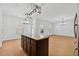 Modern kitchen featuring a center island and seamless flow into a spacious living area at 7431 St David St, Fairburn, GA 30213