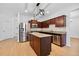 Modern kitchen featuring stainless steel appliances, center island, and wood cabinetry at 7431 St David St, Fairburn, GA 30213