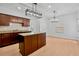 Modern kitchen featuring center island and seamlessly flowing into adjacent living area at 7431 St David St, Fairburn, GA 30213