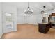 Bright, open kitchen boasts stainless appliances, dark cabinetry, and modern lighting at 7431 St David St, Fairburn, GA 30213
